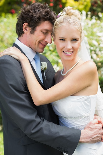 Romantic attractive newlywed couple hugging each other