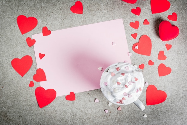 Romantic background Valentine's day Stone table with blank paper for letter congratulations hot chocolate with whipped cream and sweet hearts decorated with paper red hearts 