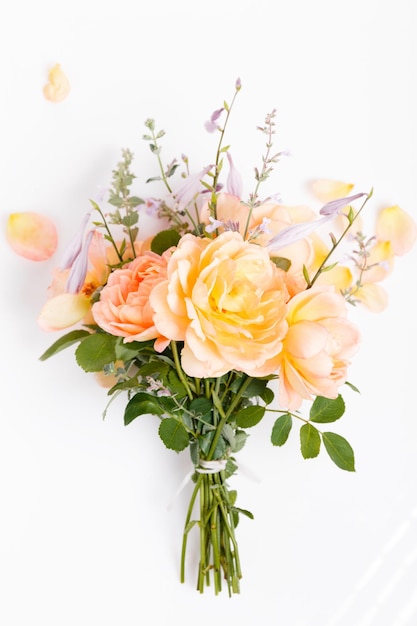 Romantic bouquet of orange english roses on a white background