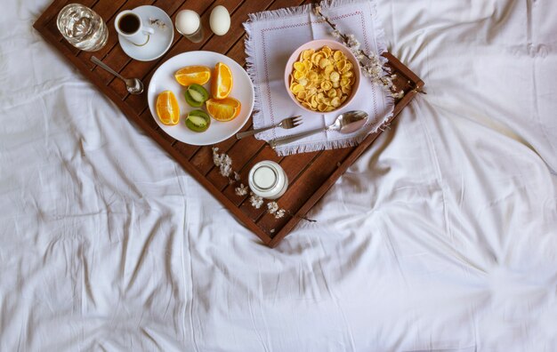 Romantic Breakfast in bed with spring flowers. Flat lay, copy space