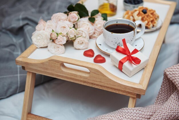 Romantic breakfast with coffee waffles gift box and rose flowers