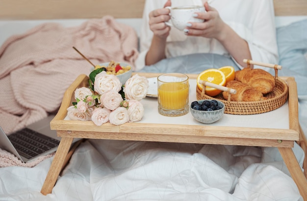 Romantic breakfast with coffee waffles orange juice and rose flowers