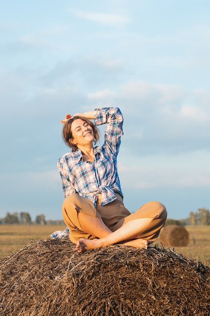 Romantic brunette woman in a plaid shirt and trousers