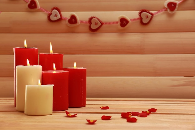 Romantic candles on wooden background, love concept