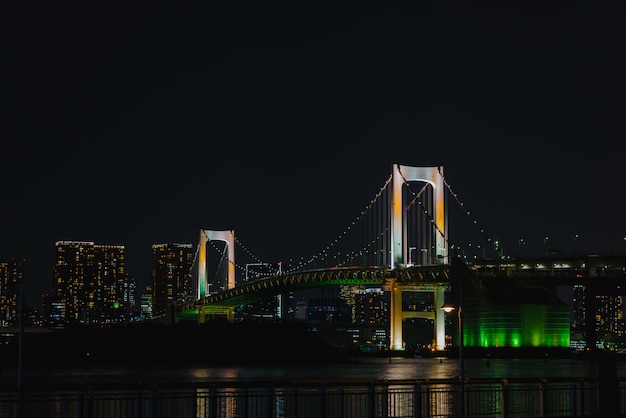 Romantic city night view, Rainbow bridge and Tokyo Tower landmark, Odaiba, Japan.