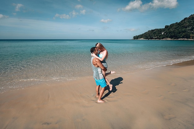 A romantic couple on the beach in a swimsuit, beautiful sexy young people. Phuket. Thailand.