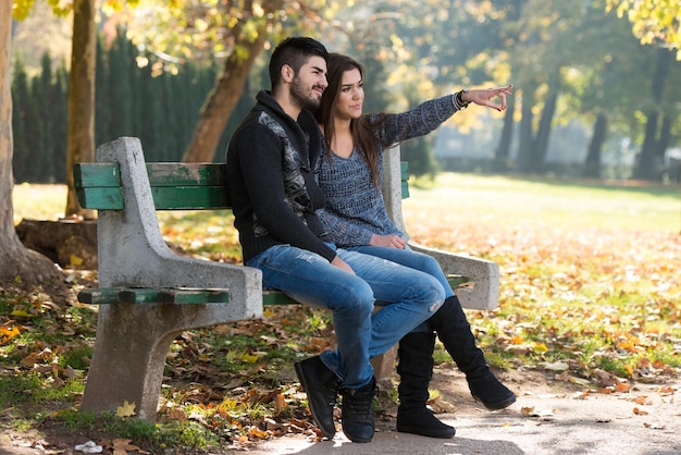 Romantic Couple On A Bench In Autumn Park