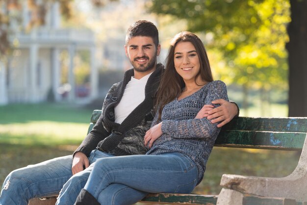 Romantic Couple On A Bench In Autumn Park