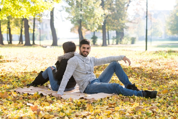 Romantic Couple On A Blanket In Autumn Park