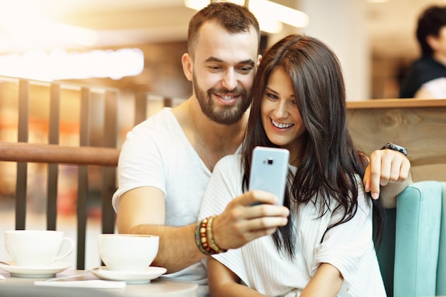 romantic couple dating in cafe and taking selfie