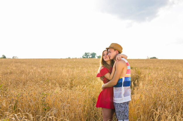 Romantic couple embraces in the field