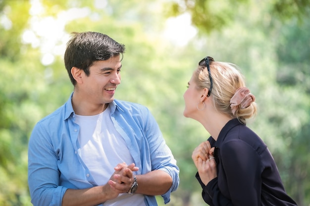 Romantic couple having a picnic relaxing in the park