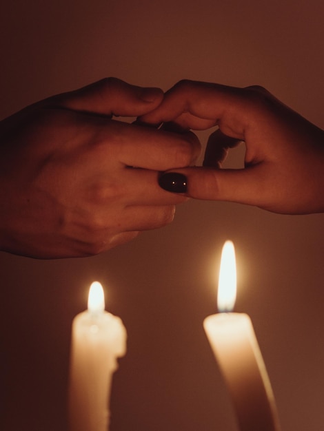 Romantic couple holding hands together over candlelight Romantic moment