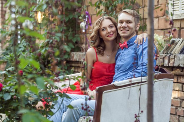 Romantic couple hugging and looking at camera with toothy smile