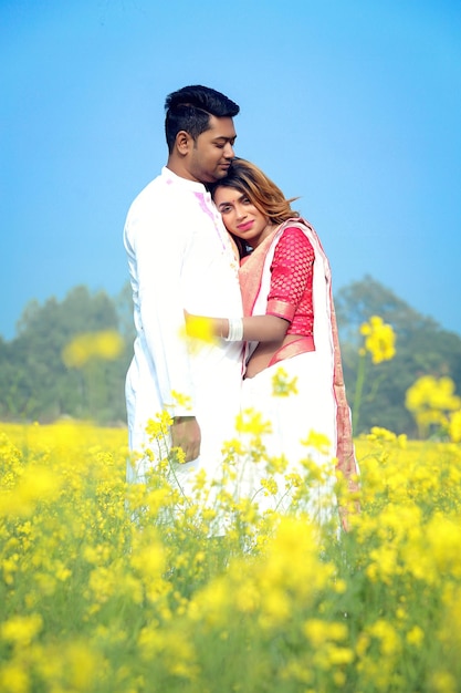 Romantic couple hugging in mustard field