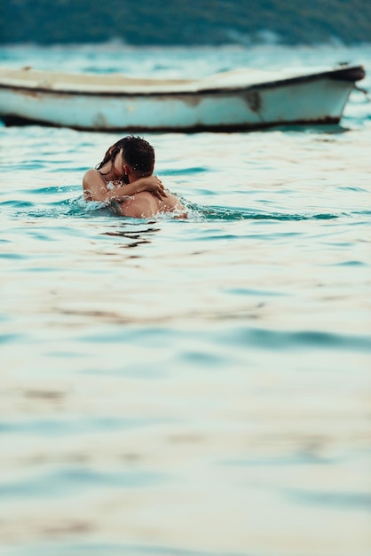 Romantic couple kissing in the sea high quality photo