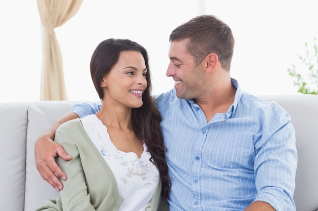 Romantic couple looking at each other on sofa