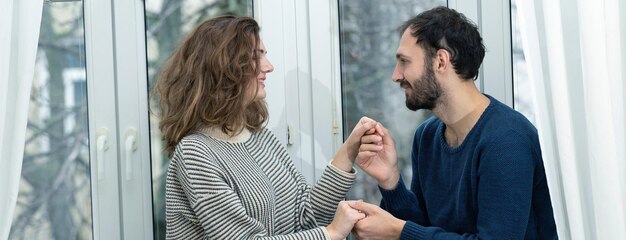 Romantic couple looking out of the window Quarantine at home