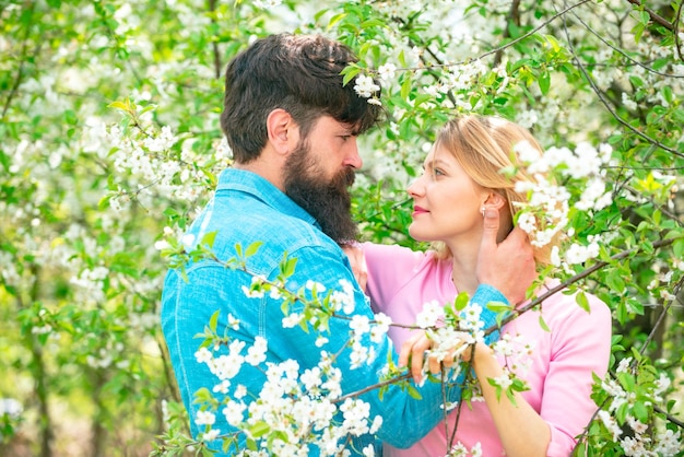 Romantic couple in love feeling happiness Happy couple in love outdoors Happy couple smiling in a spring park on a sunny day