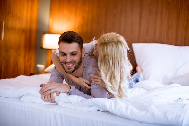 Romantic couple in love lying in bed together