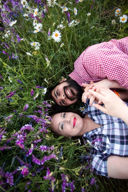 Romantic couple love moment in field among wild flowers