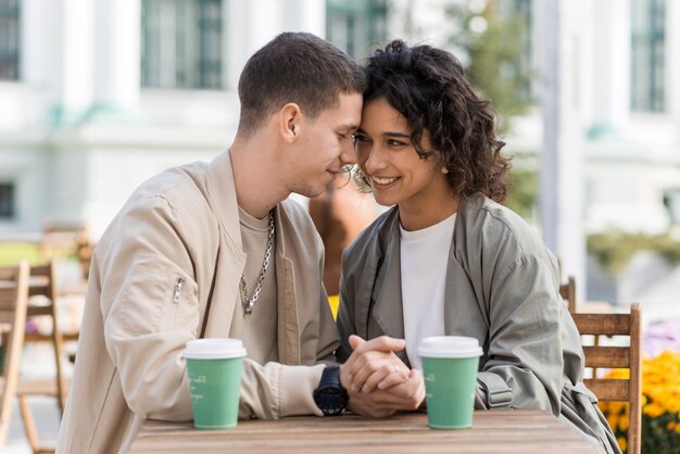 A romantic couple outdoors near a cafe