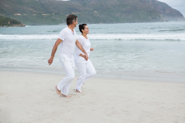 Romantic couple running on beach