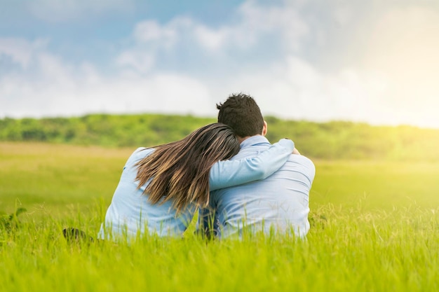 Premium Photo | Romantic couple sitting on the grass hugging from the back rear view of a couple in love hugging on the grass a couple in love sitting on the grass Premium Photo | Romantic couple sitting on the grass hugging from the back rear view of a couple in love hugging on the grass a couple in love sitting on the grass