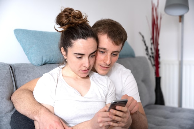 Romantic couple using phone and checking social media