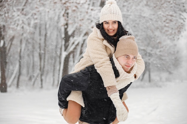 Romantic couple walking in forest at winter day