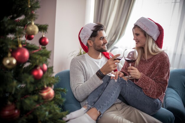 Romantic couple with red wine at home