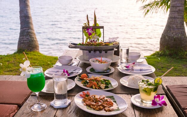 Romantic dinner on the beach with thai food during sunset on the island koh mak thailand