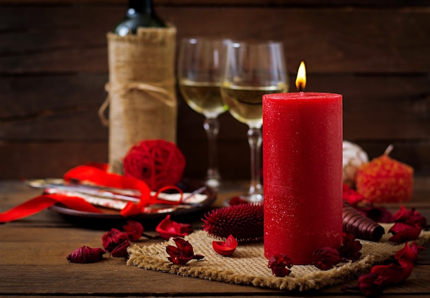 Romantic dinner setting, candles, wine and decor