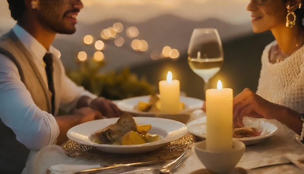 Romantic dinner with wine glasses and candles on terrace in sunset