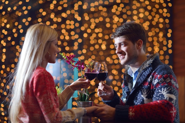 romantic evening date in restaurant  happy young couple with wine glass tea and cake