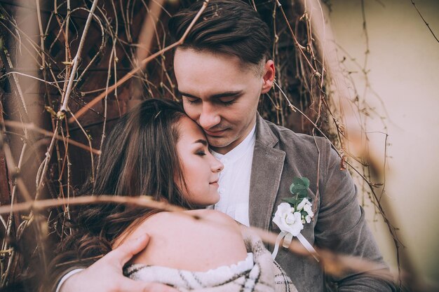 Romantic fairytale newlywed couple hug and kiss