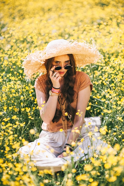 Romantic hippie girl standing in a field. Summer. Hippie style.