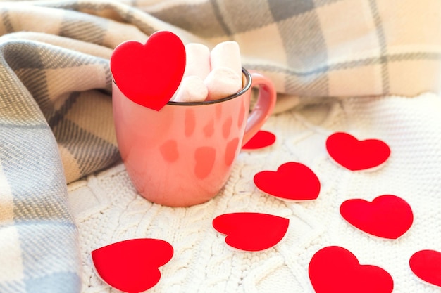 Romantic holiday composition with hot drink and red hearts