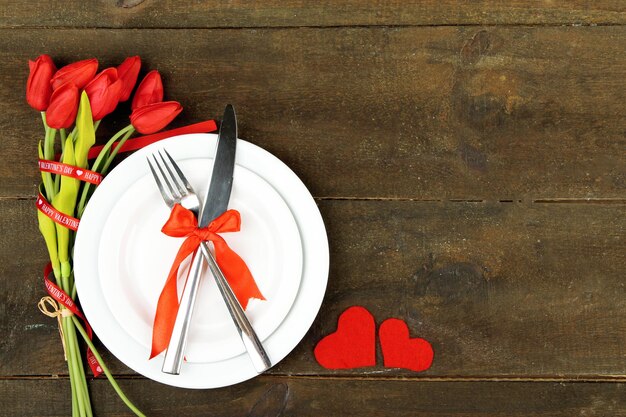 Romantic holiday table setting, on wooden background