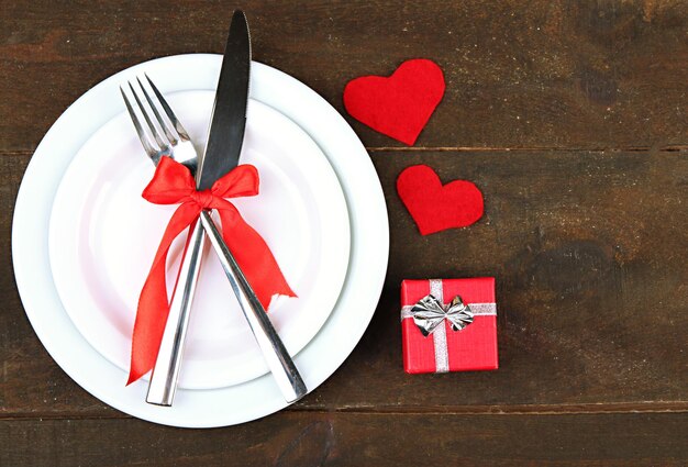 Romantic holiday table setting, on wooden background