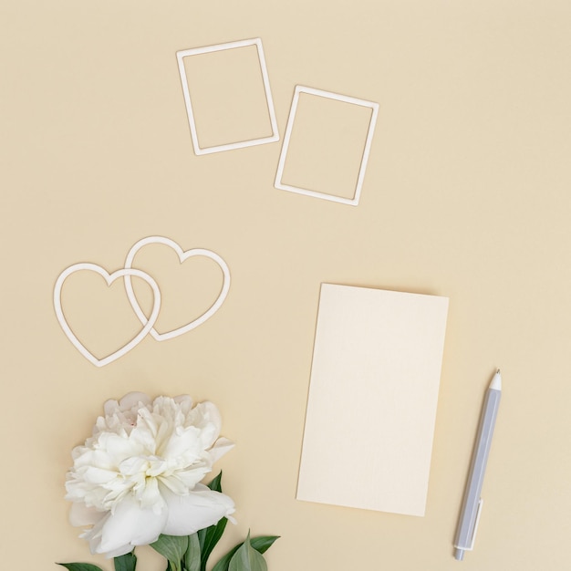 Romantic holiday or Valentines Day flat lay with fresh white peony flower postcards for wishes