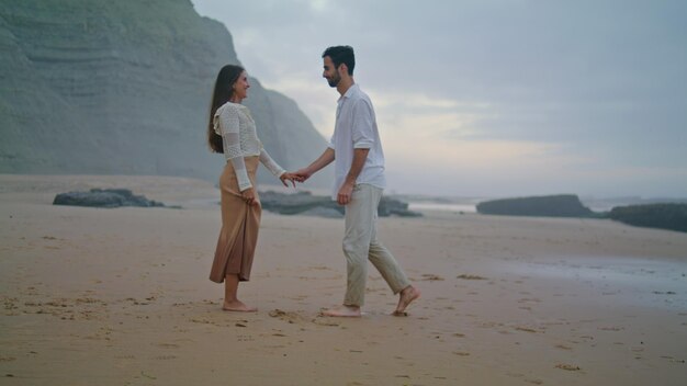 Romantic man proposing marriage to woman at beach couple celebrating engagement