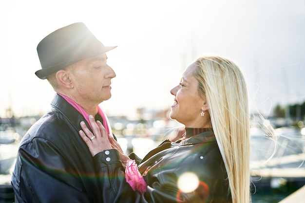 Romantic middleaged couple embracing the port