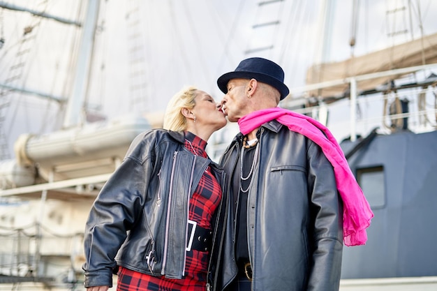 Romantic middleaged couple kissing in the harbor