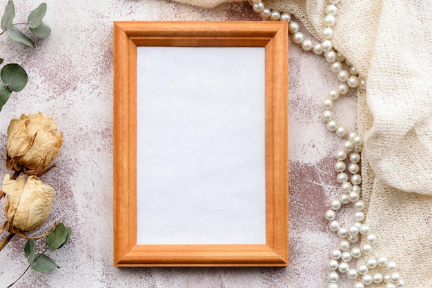 Romantic natural gentle backgroundclean photo frame and twigs of dry grass and flowers Top view closeup and copy space Wedding and gift fund