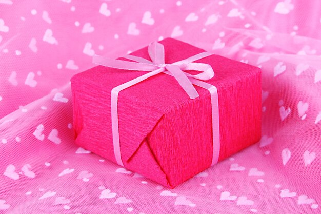 Romantic parcel on pink cloth background