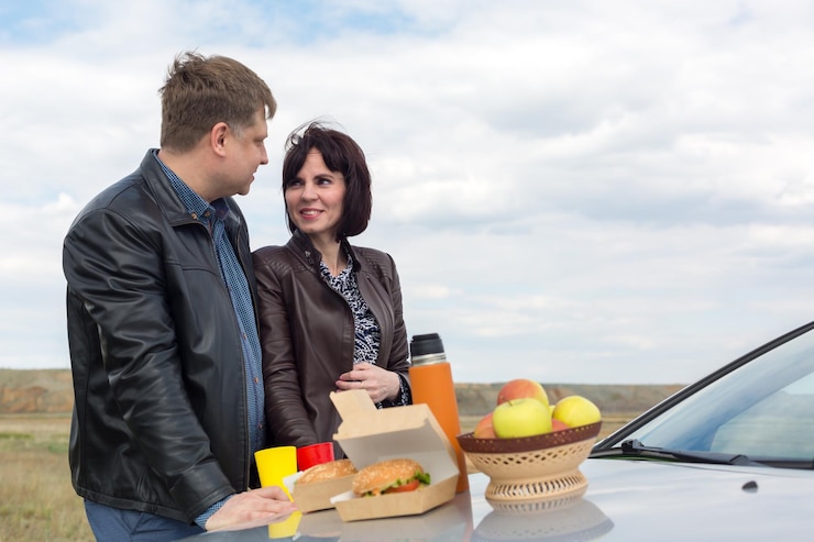 फोटो romantic picnic in nature on the hood of a car