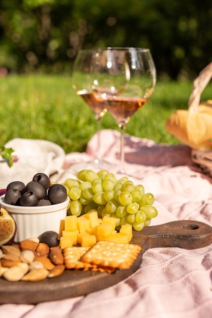 Romantic picnic with wine in a summer garden