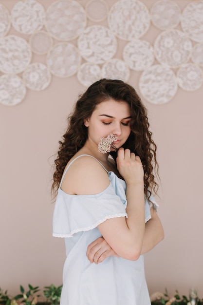 romantic portrait of a beautiful girl in a dress indoors