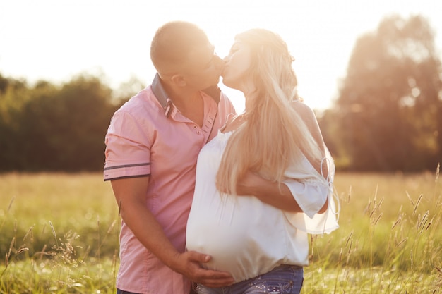 Romantic portrait of future parents kiss and express love.